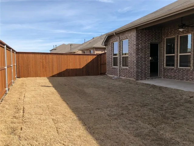 a view of a backyard of the house
