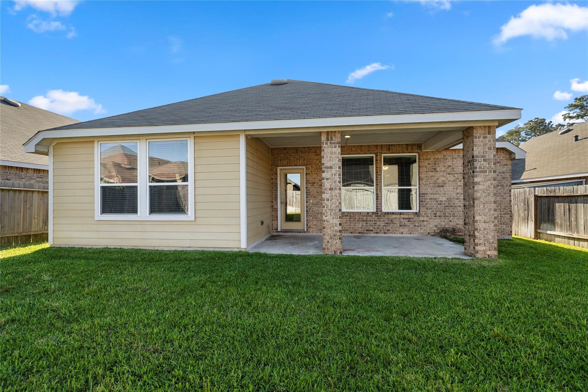 29507 Whitebrush Trace Drive Spring, TX 77386 - Photo 4 of 32 Rear exterior view with covered patio and backyard.
