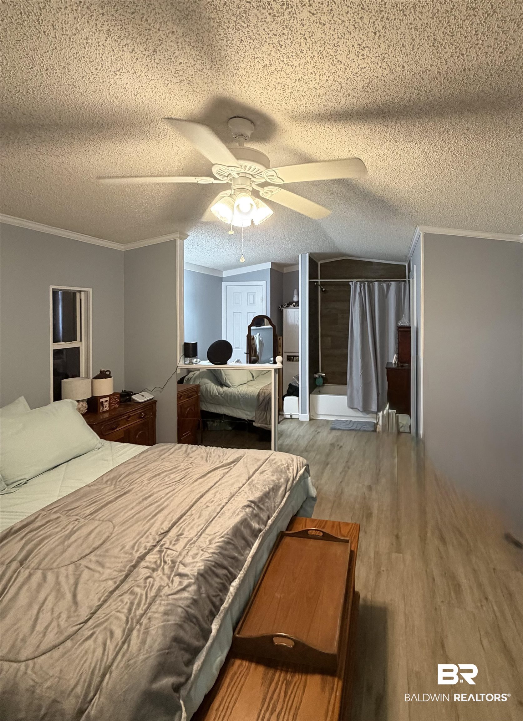 1913 Maria Lane Lillian, AL 36549 - Photo 9 of 35 Bedroom featuring crown molding, wood finished floors, ceiling fan, a textured ceiling, and vaulted ceiling