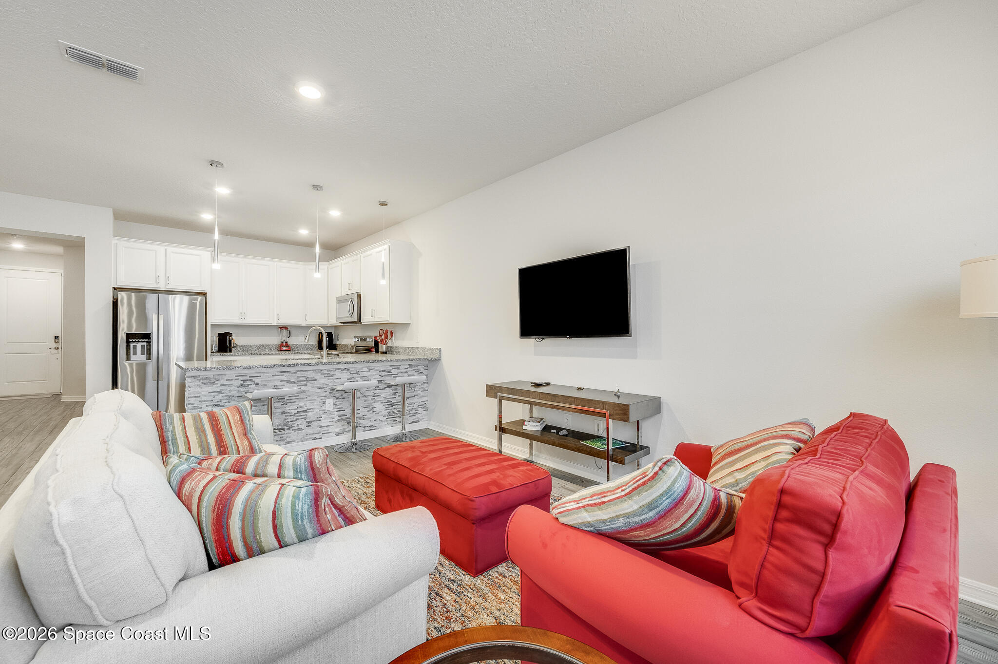 2202 Gopher Tortoise Terrace Oakland, FL 34787 - Photo 11 of 42 a living room with furniture kitchen and a flat screen tv