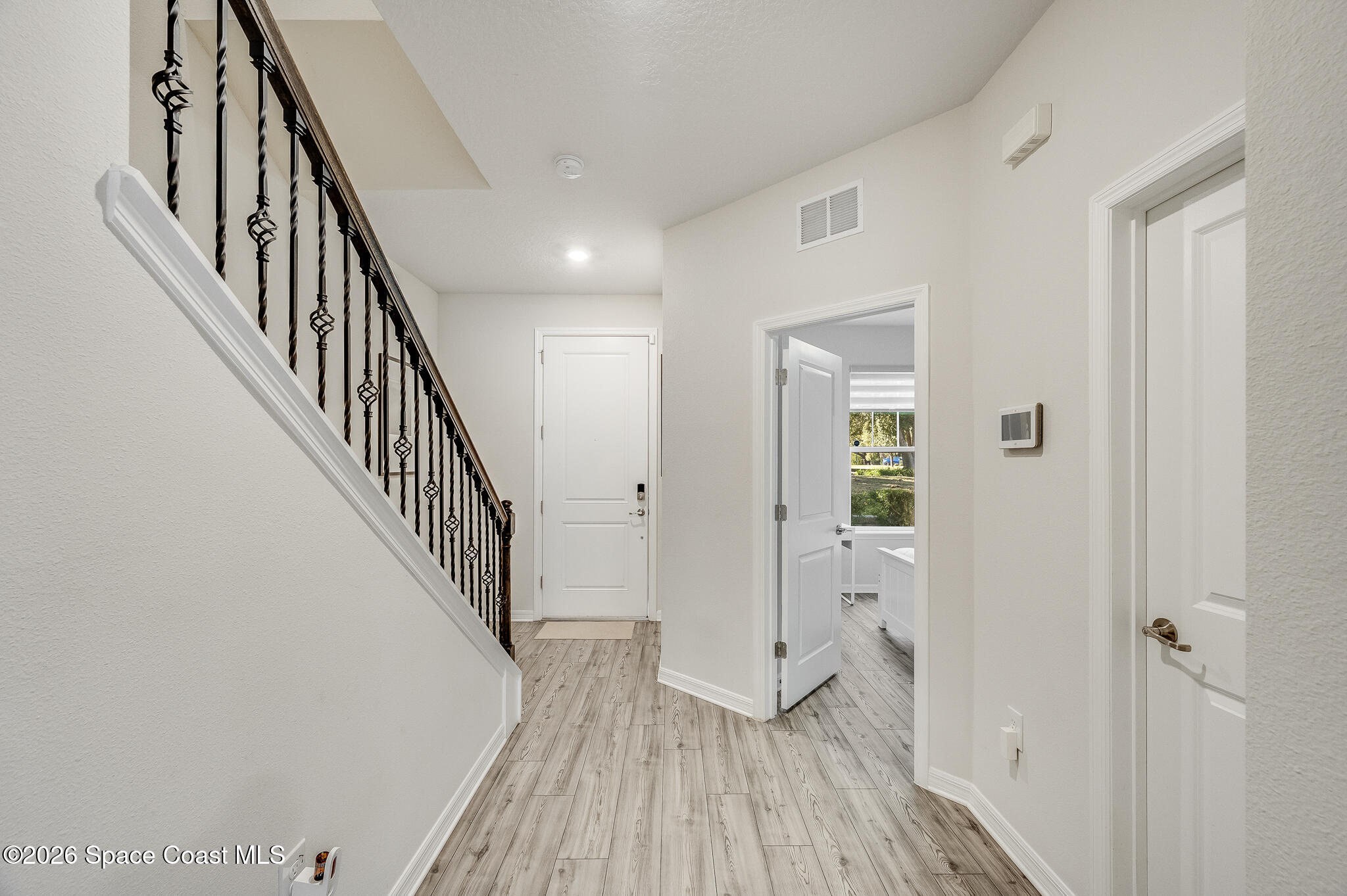 2202 Gopher Tortoise Terrace Oakland, FL 34787 - Photo 12 of 42 a view of a hallway with wooden floor and staircase