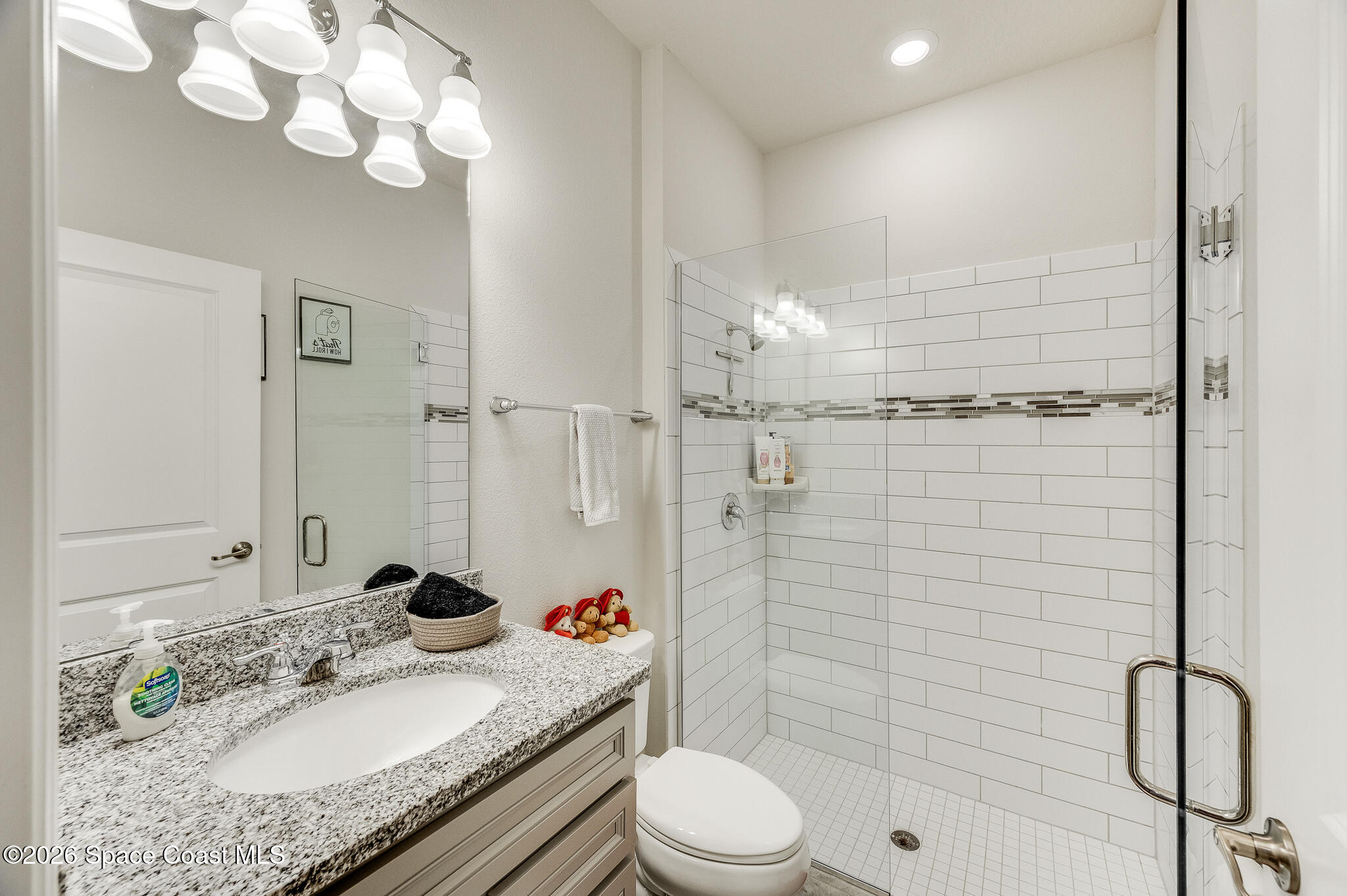 2202 Gopher Tortoise Terrace Oakland, FL 34787 - Photo 15 of 42 a bathroom with a granite countertop sink a toilet and shower