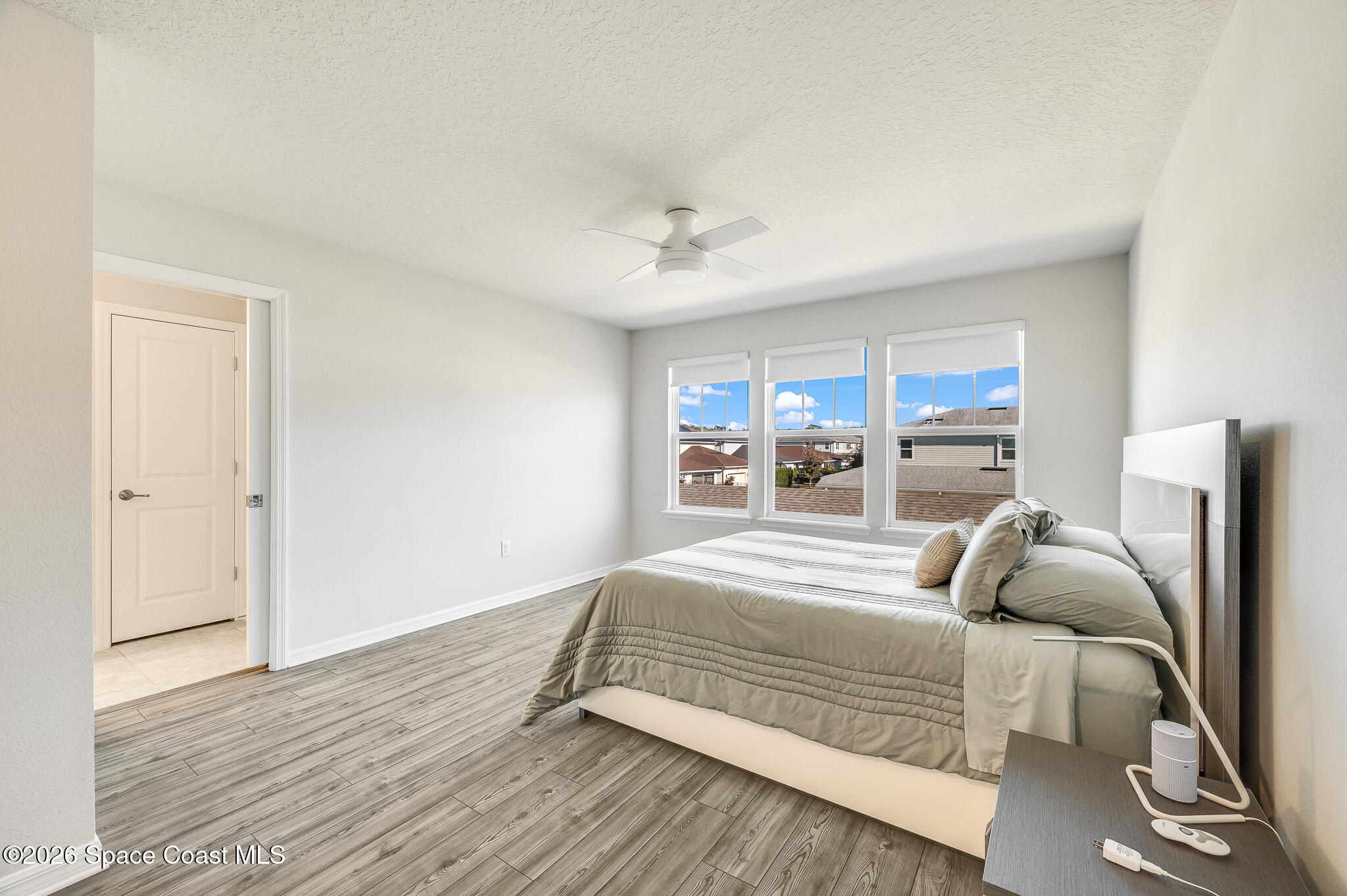 2202 Gopher Tortoise Terrace Oakland, FL 34787 - Photo 20 of 42 a bedroom with a large bed and a chandelier