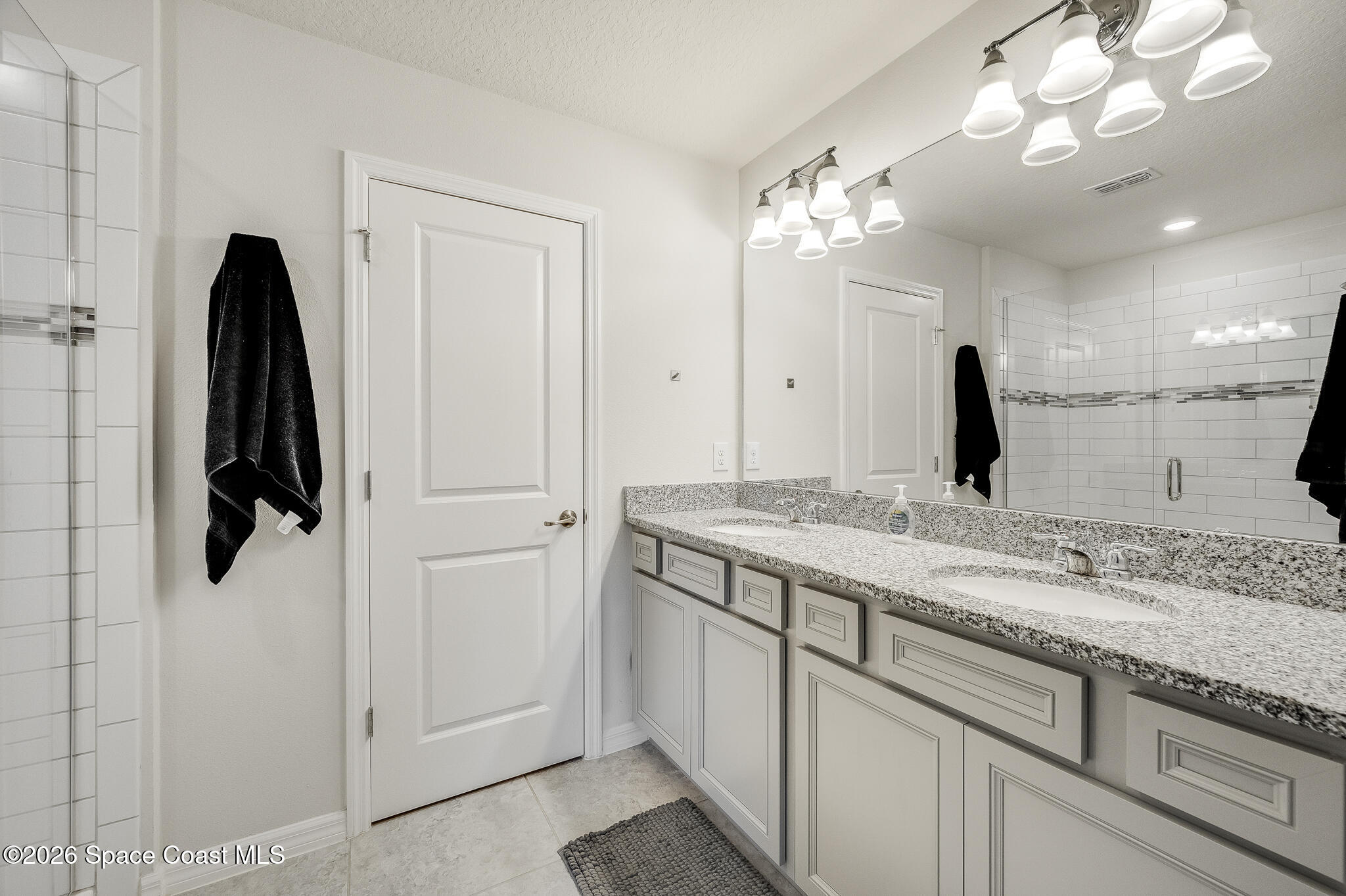 2202 Gopher Tortoise Terrace Oakland, FL 34787 - Photo 25 of 42 a bathroom with a sink vanity and a mirror