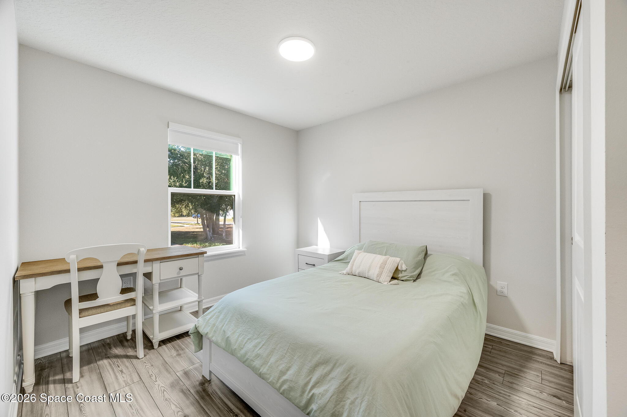 2202 Gopher Tortoise Terrace Oakland, FL 34787 - Photo 33 of 42 a bedroom with a bed and wooden floor