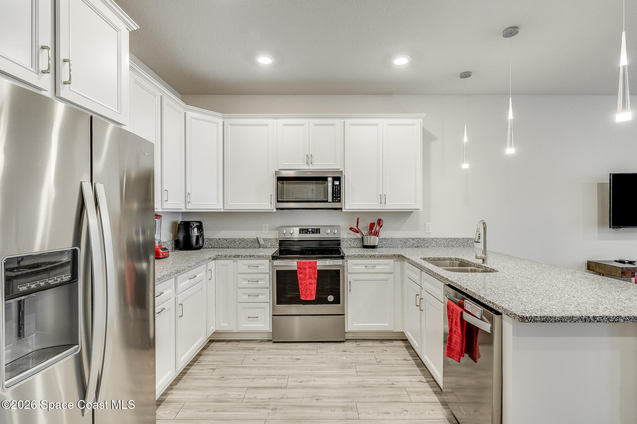 2202 Gopher Tortoise Terrace Oakland, FL 34787 - Photo 5 of 42 a kitchen with stainless steel appliances granite countertop a stove top oven a refrigerator and a sink