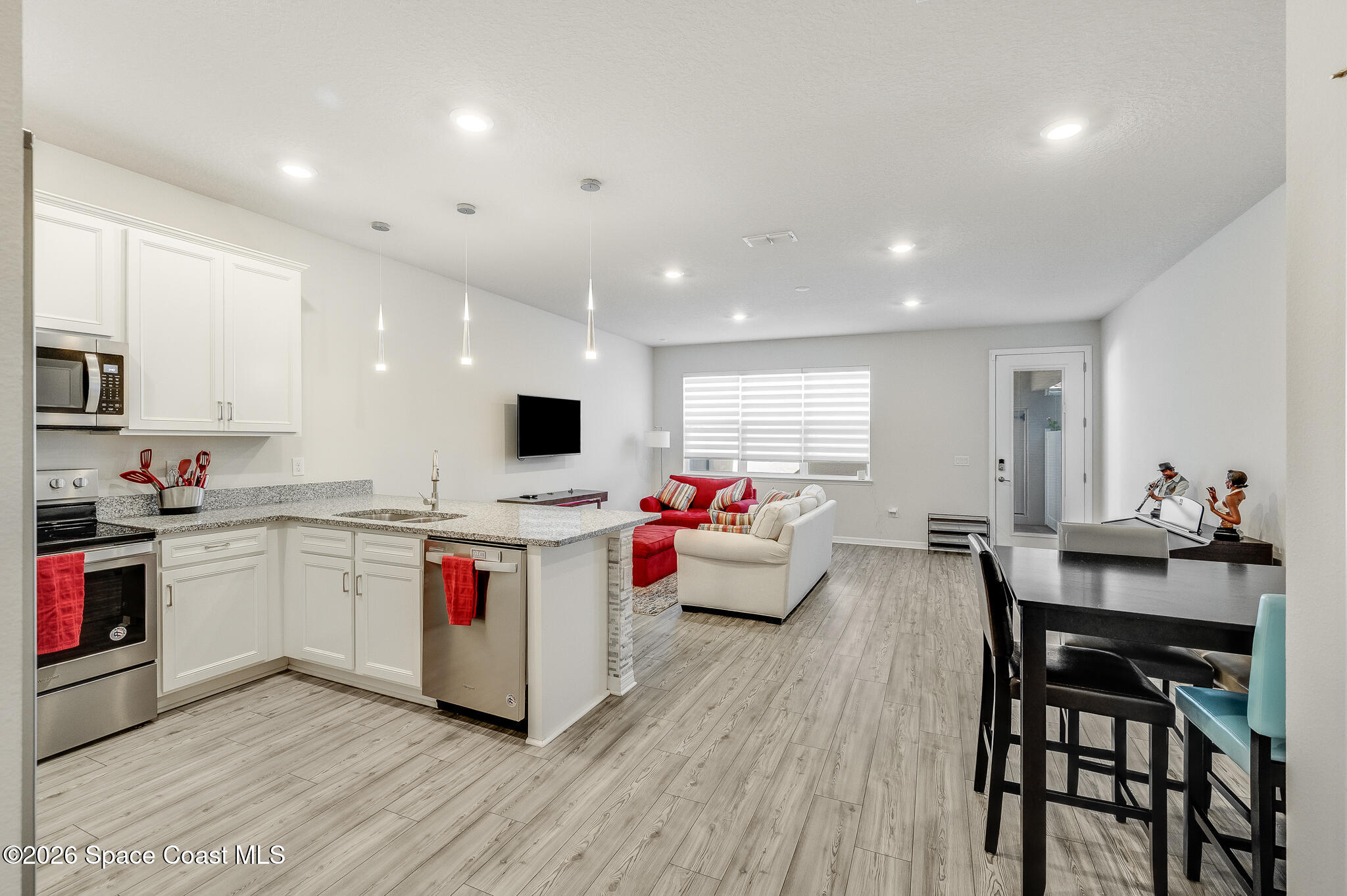 2202 Gopher Tortoise Terrace Oakland, FL 34787 - Photo 7 of 42 a kitchen with sink a stove and chairs