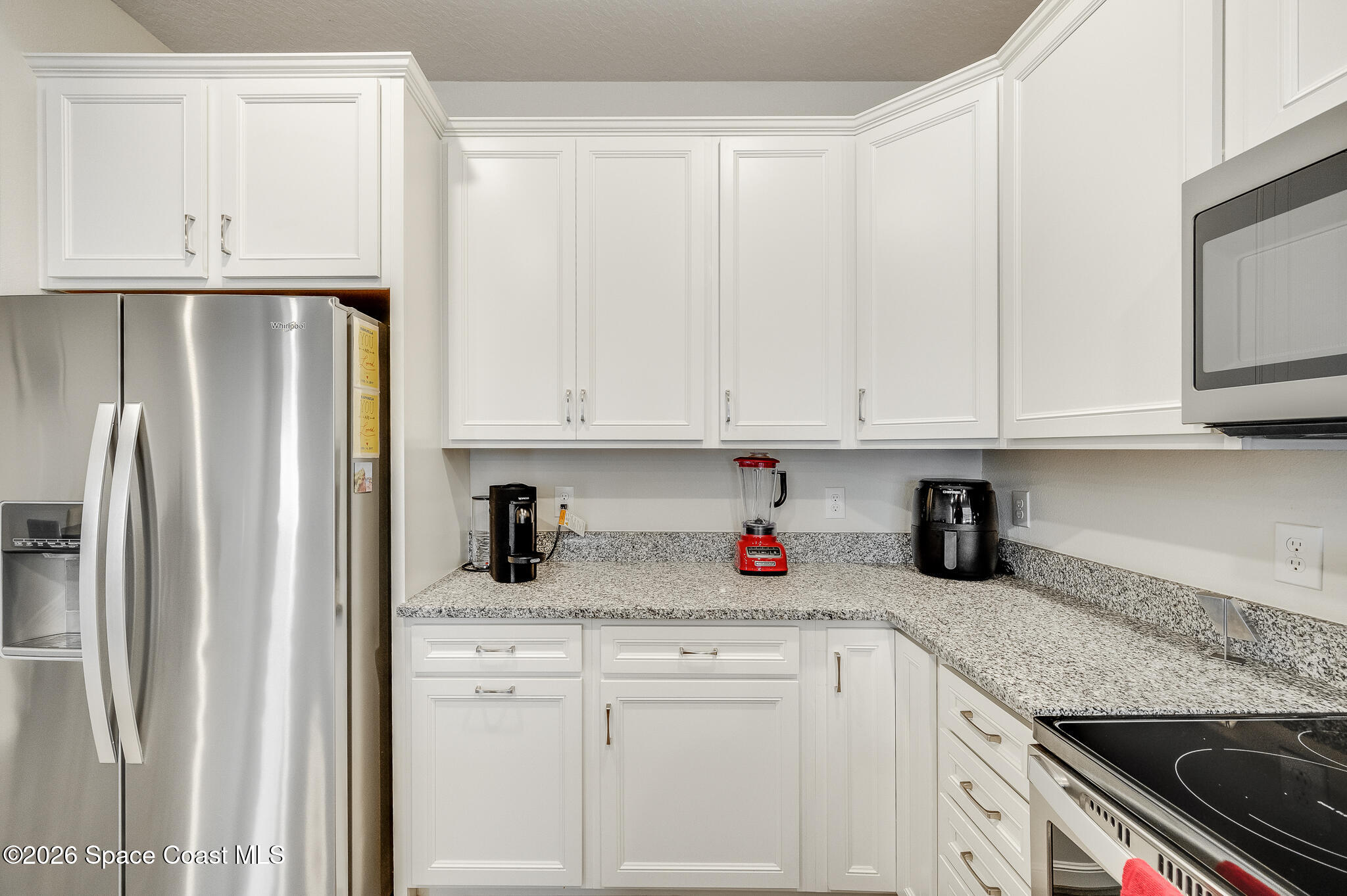 2202 Gopher Tortoise Terrace Oakland, FL 34787 - Photo 8 of 42 a kitchen with stainless steel appliances granite countertop white cabinets and a refrigerator