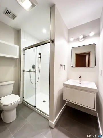 a bathroom with a toilet and a shower
