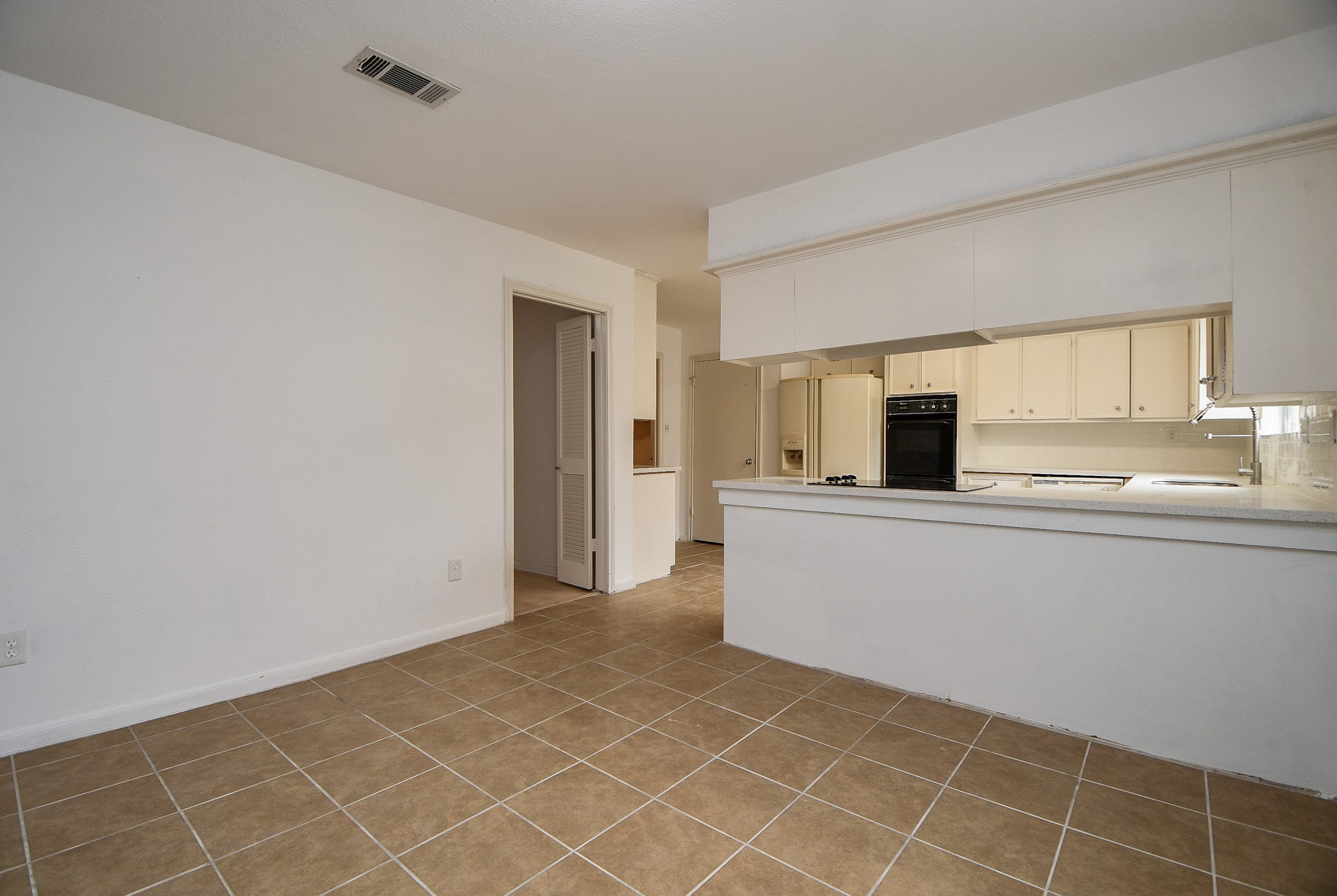 6411 Teal Run Drive Houston, TX 77035 - Photo 13 of 32 a view of a kitchen with an empty space and window