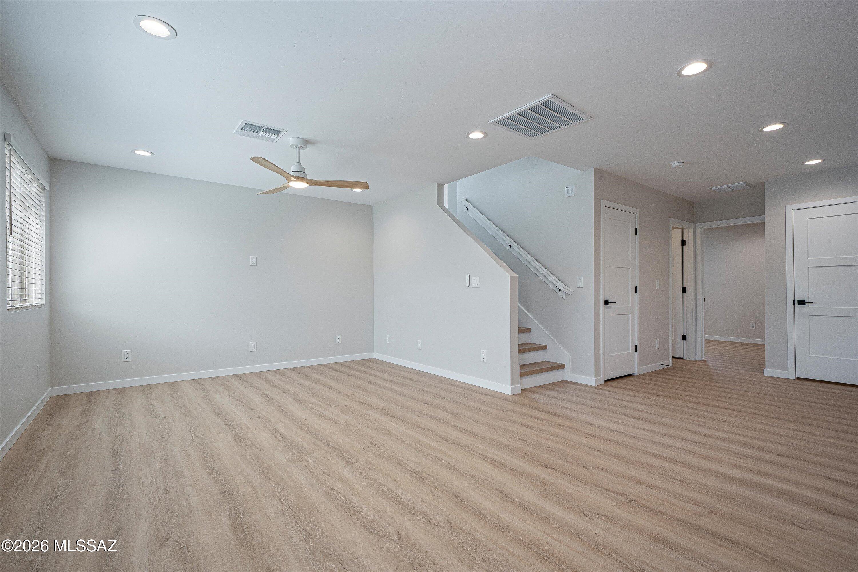 739 North Queen Avenue, Unit 2 Tucson, AZ 85705 - Photo 5 of 28 an empty room with wooden floor and natural light