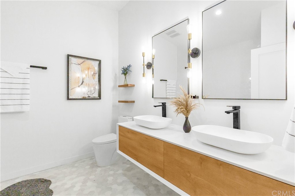 832 Mountain View Street Altadena, CA 91001 - Photo 11 of 39 a bathroom with a double vanity sink toilet and mirror
