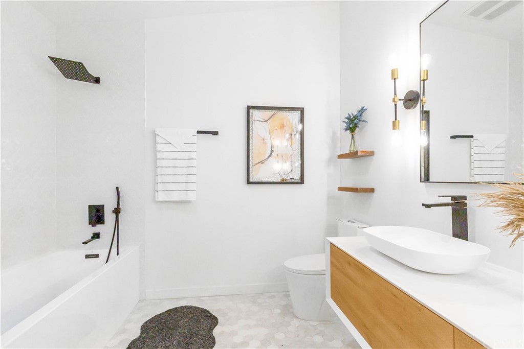 832 Mountain View Street Altadena, CA 91001 - Photo 12 of 39 a bathroom with a granite countertop sink and a mirror