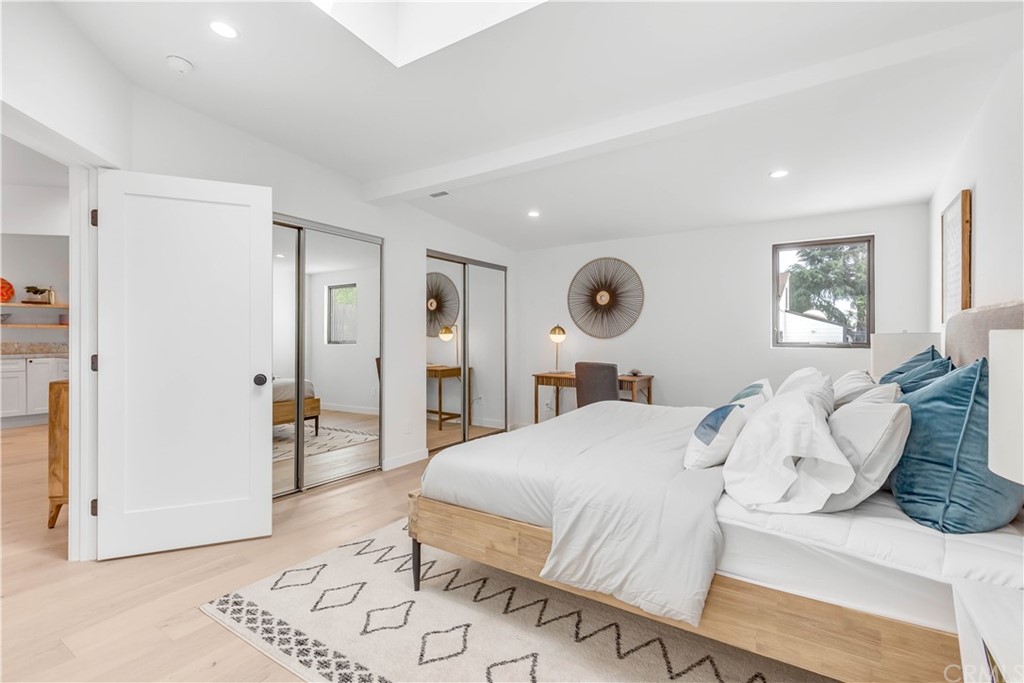 832 Mountain View Street Altadena, CA 91001 - Photo 15 of 39 a bedroom with a large bed and a chandelier