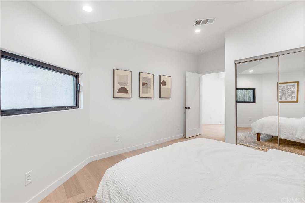 832 Mountain View Street Altadena, CA 91001 - Photo 18 of 39 a bedroom with a bed and a large mirror