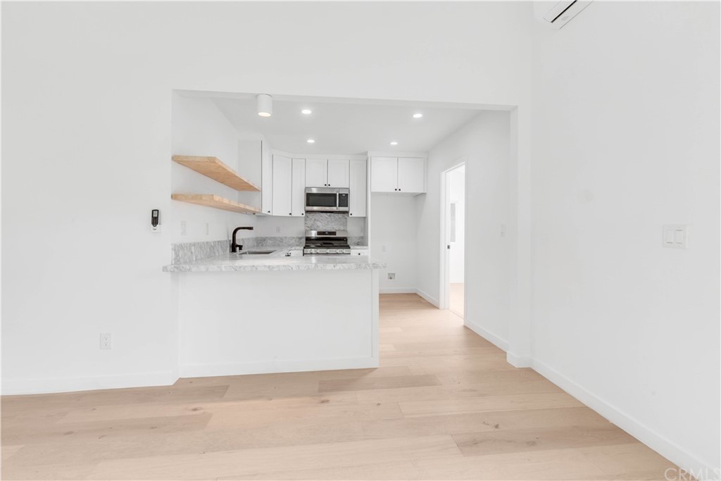 832 Mountain View Street Altadena, CA 91001 - Photo 27 of 39 a view of kitchen with kitchen island white cabinetry and refrigerator
