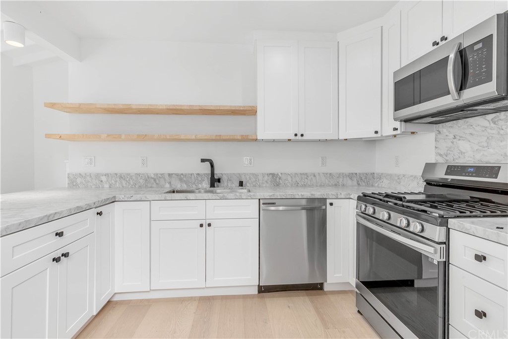832 Mountain View Street Altadena, CA 91001 - Photo 29 of 39 a kitchen with stainless steel appliances granite countertop a sink and a stove