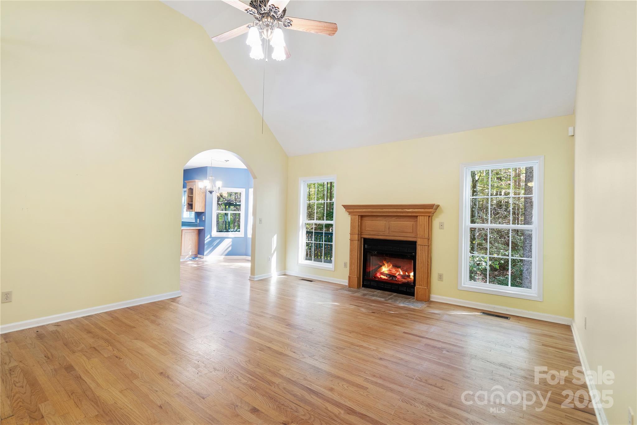 236 Woody Circle Tryon, NC 28782 - Photo 5 of 26 a view of an empty room with wooden floor fireplace and a window