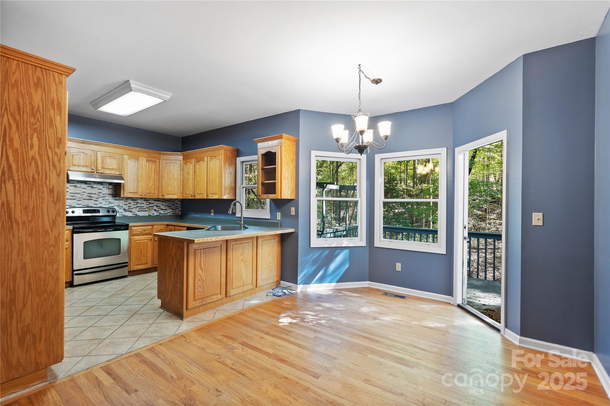 236 Woody Circle Tryon, NC 28782 - Photo 6 of 26 a open kitchen with granite countertop a stove top oven a sink and dishwasher a refrigerator with wooden floor