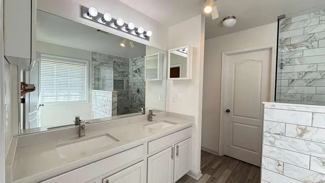 a bathroom with a double vanity sink and a mirror