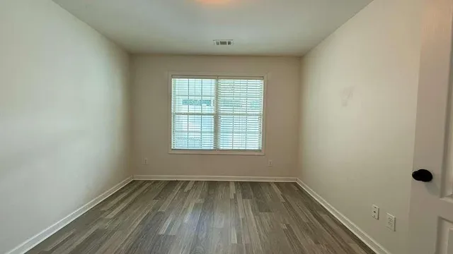 a view of a room with wooden floor and a fireplace