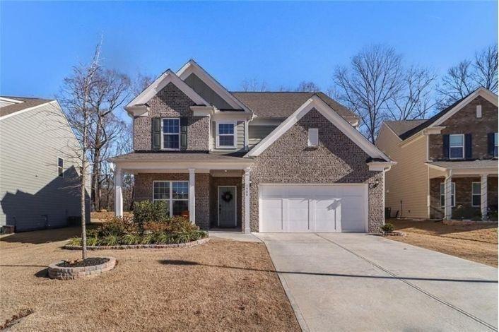 a front view of a house with a yard and garage