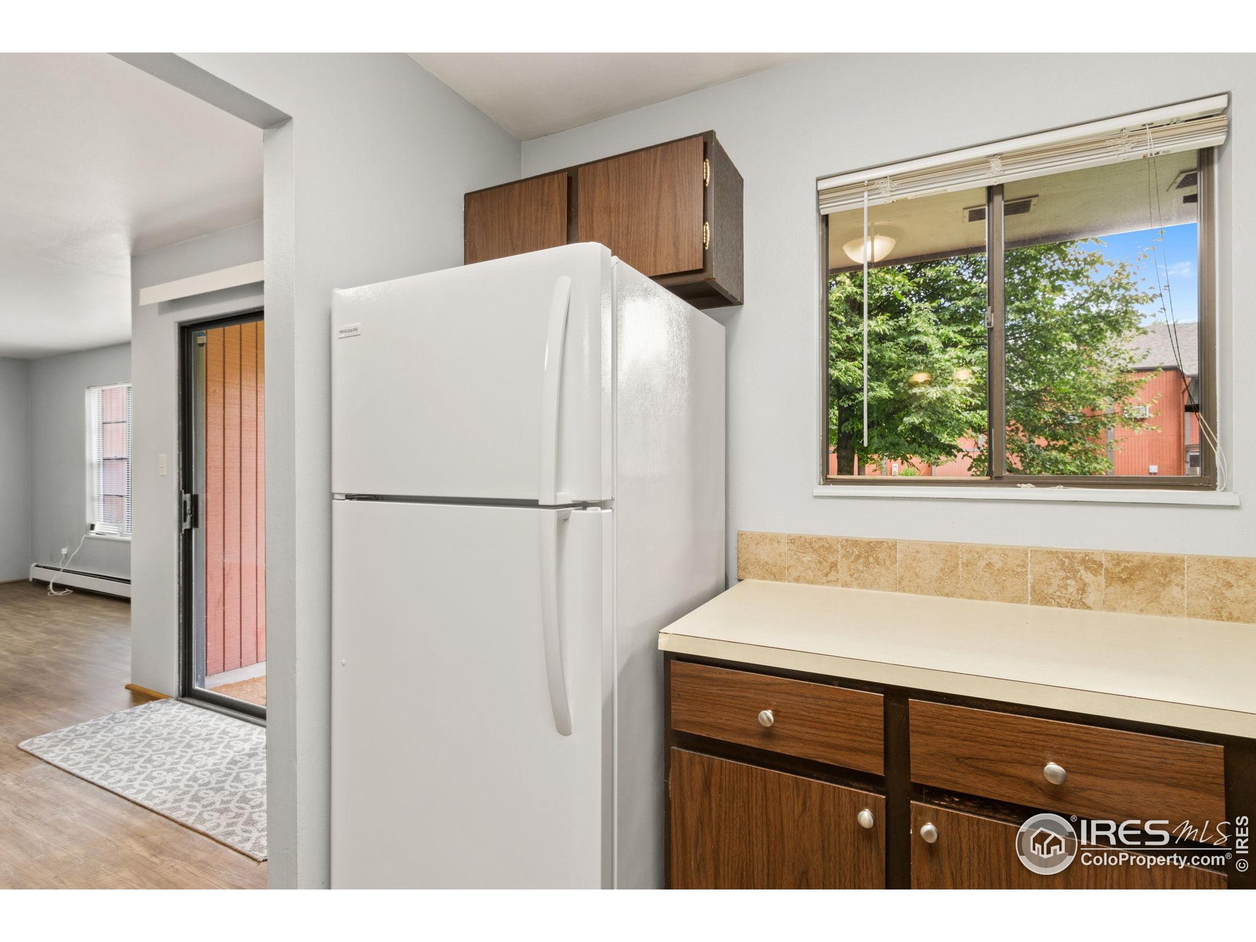 1625 West Elizabeth Street, Unit G2 Fort Collins, CO 80521 - Photo 11 of 45 a kitchen with a refrigerator and a sink