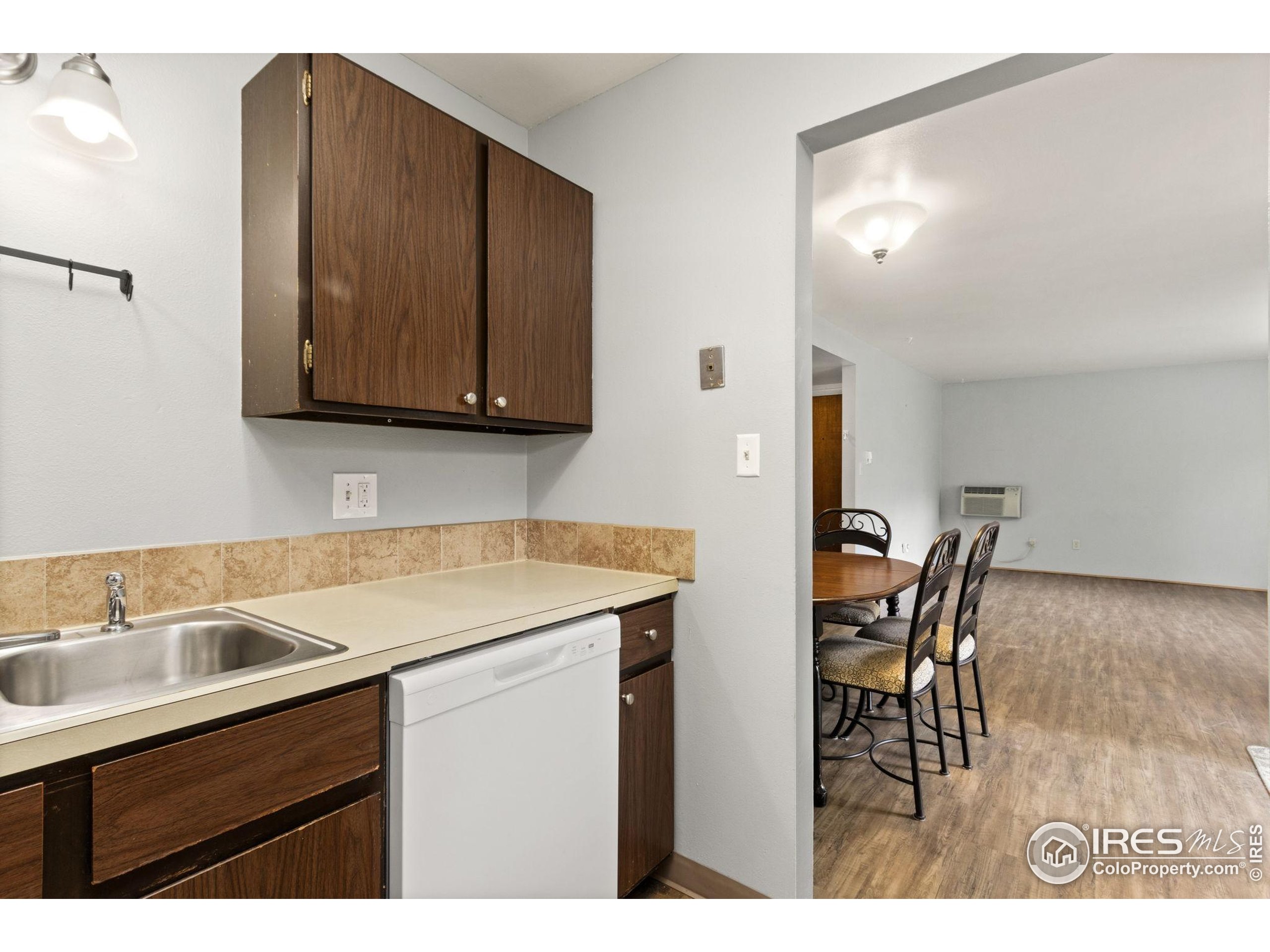 1625 West Elizabeth Street, Unit G2 Fort Collins, CO 80521 - Photo 12 of 45 a kitchen with a sink cabinets and wooden floor