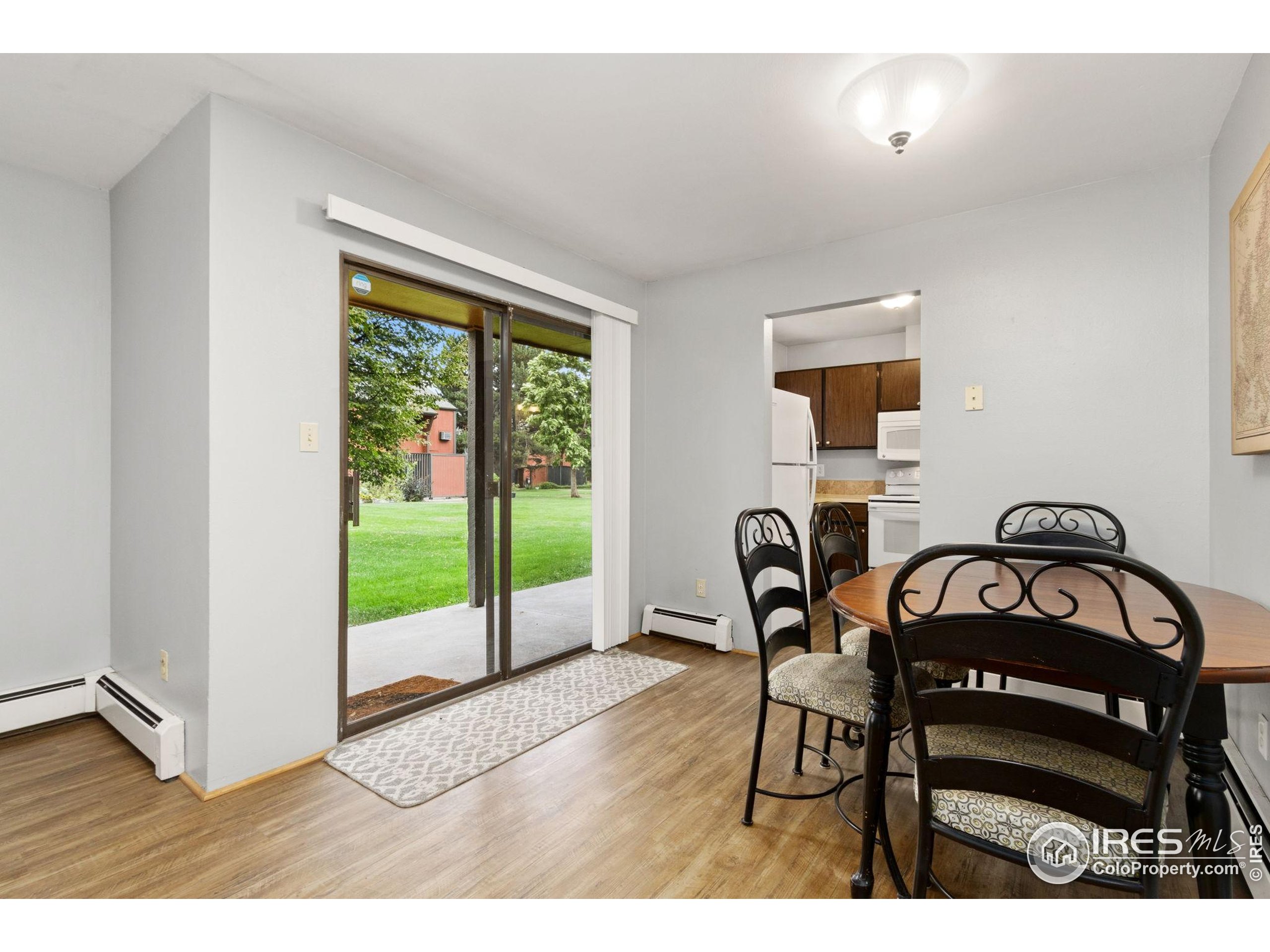 1625 West Elizabeth Street, Unit G2 Fort Collins, CO 80521 - Photo 14 of 45 a view of a dining room with furniture and a floor to ceiling window