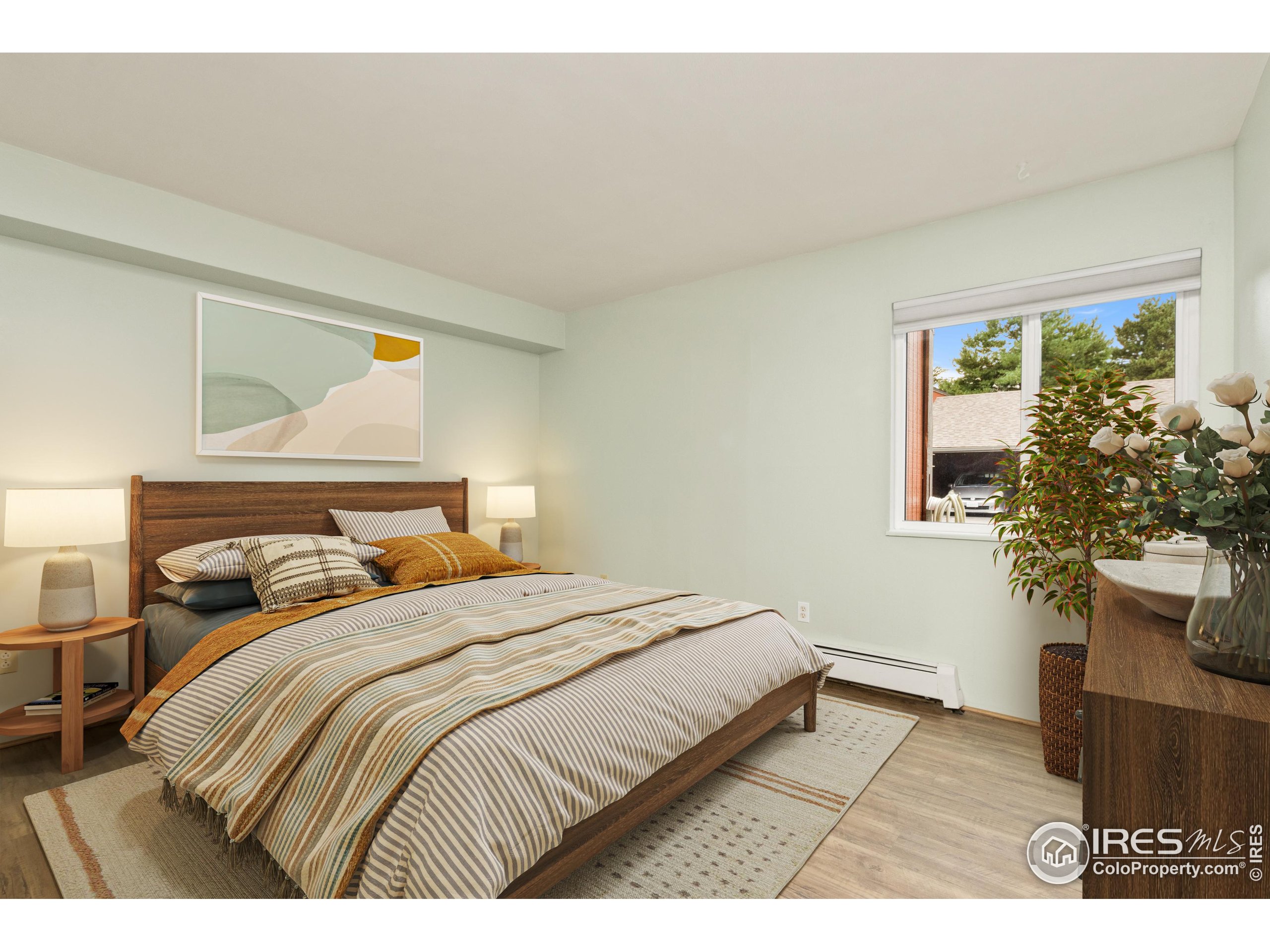 1625 West Elizabeth Street, Unit G2 Fort Collins, CO 80521 - Photo 17 of 45 a bedroom with a bed and a potted plant