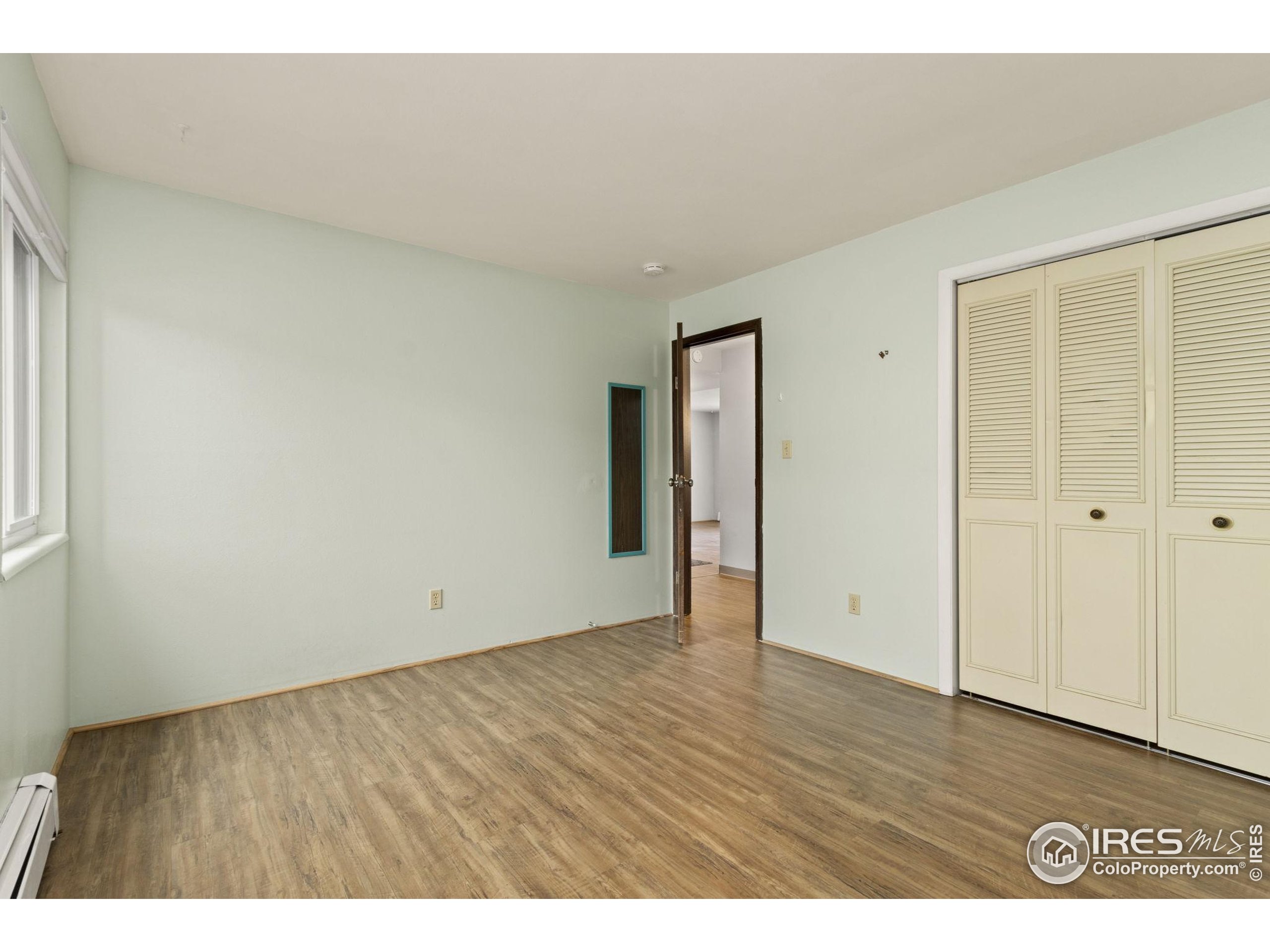 1625 West Elizabeth Street, Unit G2 Fort Collins, CO 80521 - Photo 19 of 45 a view of an empty room with wooden floor