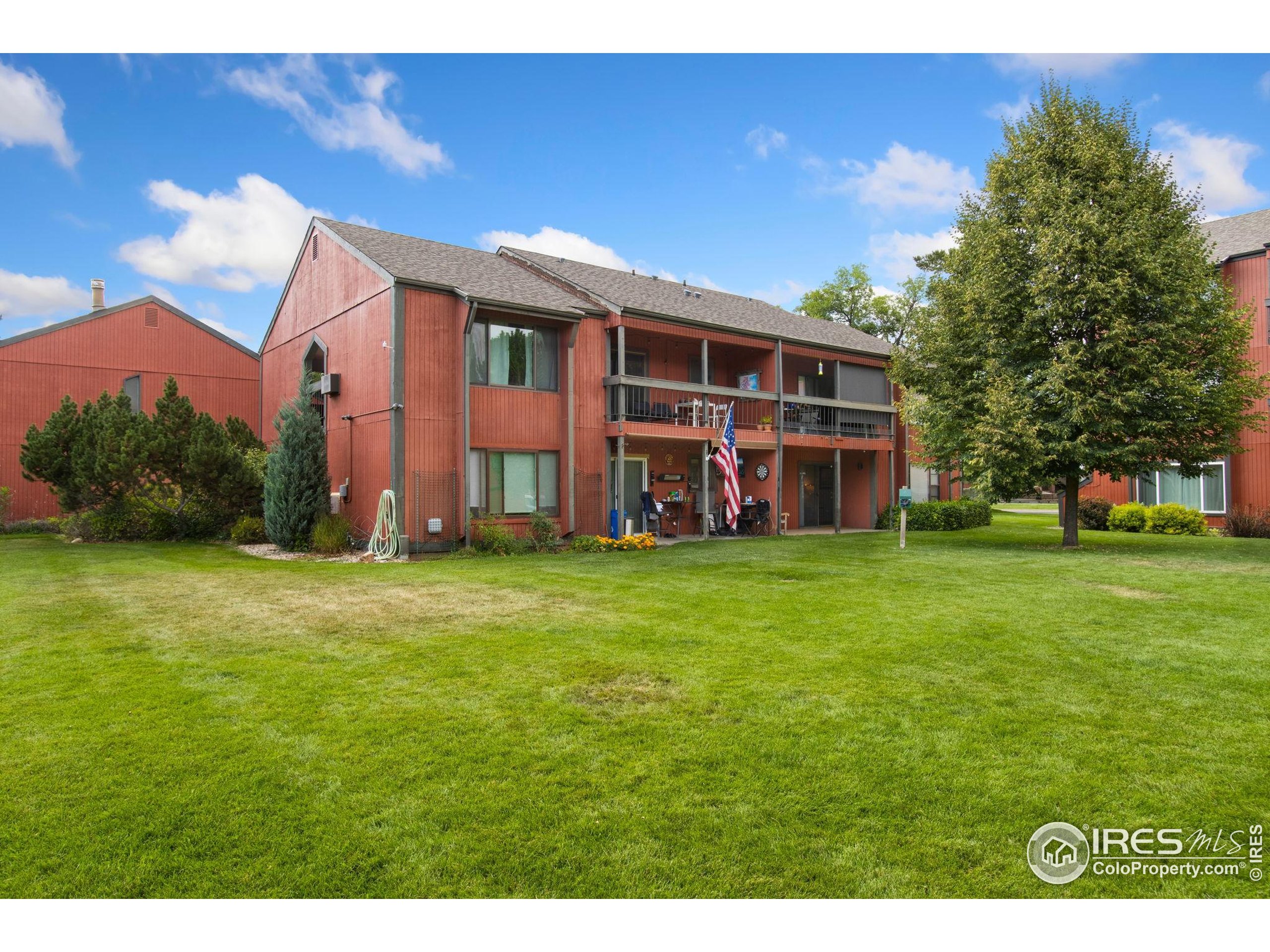 1625 West Elizabeth Street, Unit G2 Fort Collins, CO 80521 - Photo 37 of 45 a view of a house with a big yard and large trees