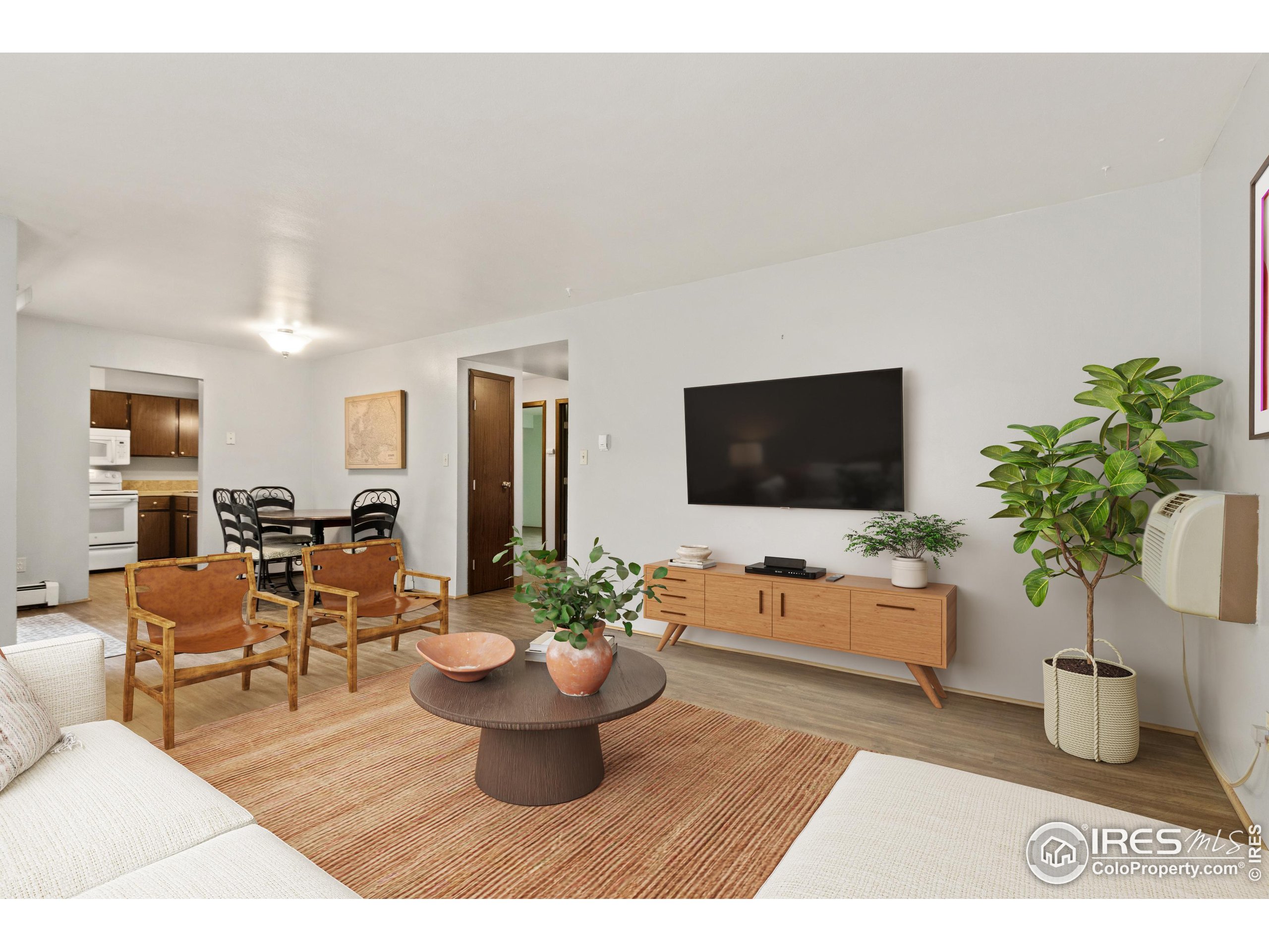 1625 West Elizabeth Street, Unit G2 Fort Collins, CO 80521 - Photo 6 of 45 a living room with furniture potted plant and a flat screen tv