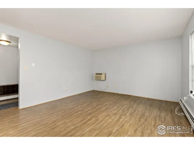 a view of an empty room and wooden floor