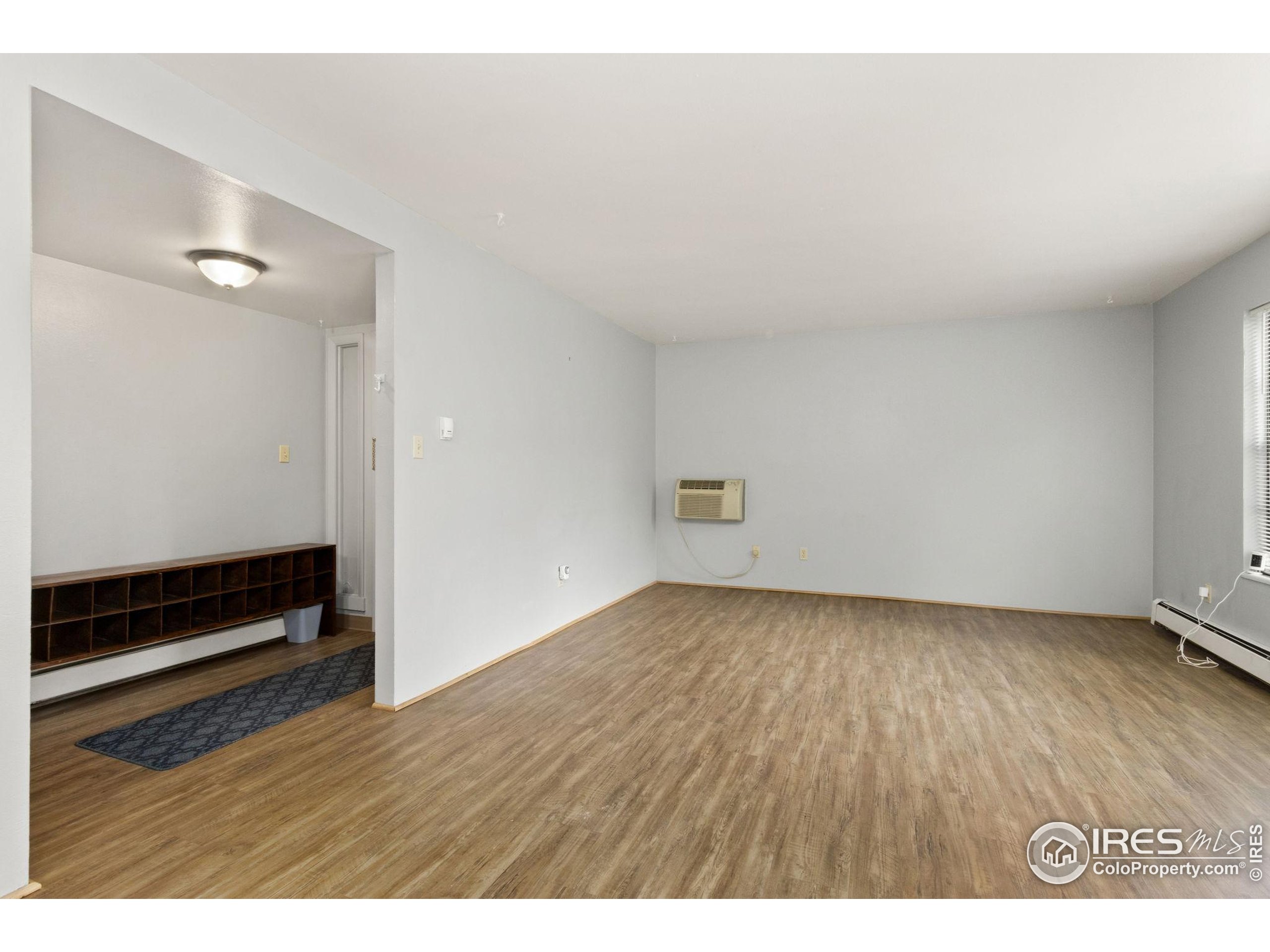 1625 West Elizabeth Street, Unit G2 Fort Collins, CO 80521 - Photo 9 of 45 a view of an empty room with wooden floor