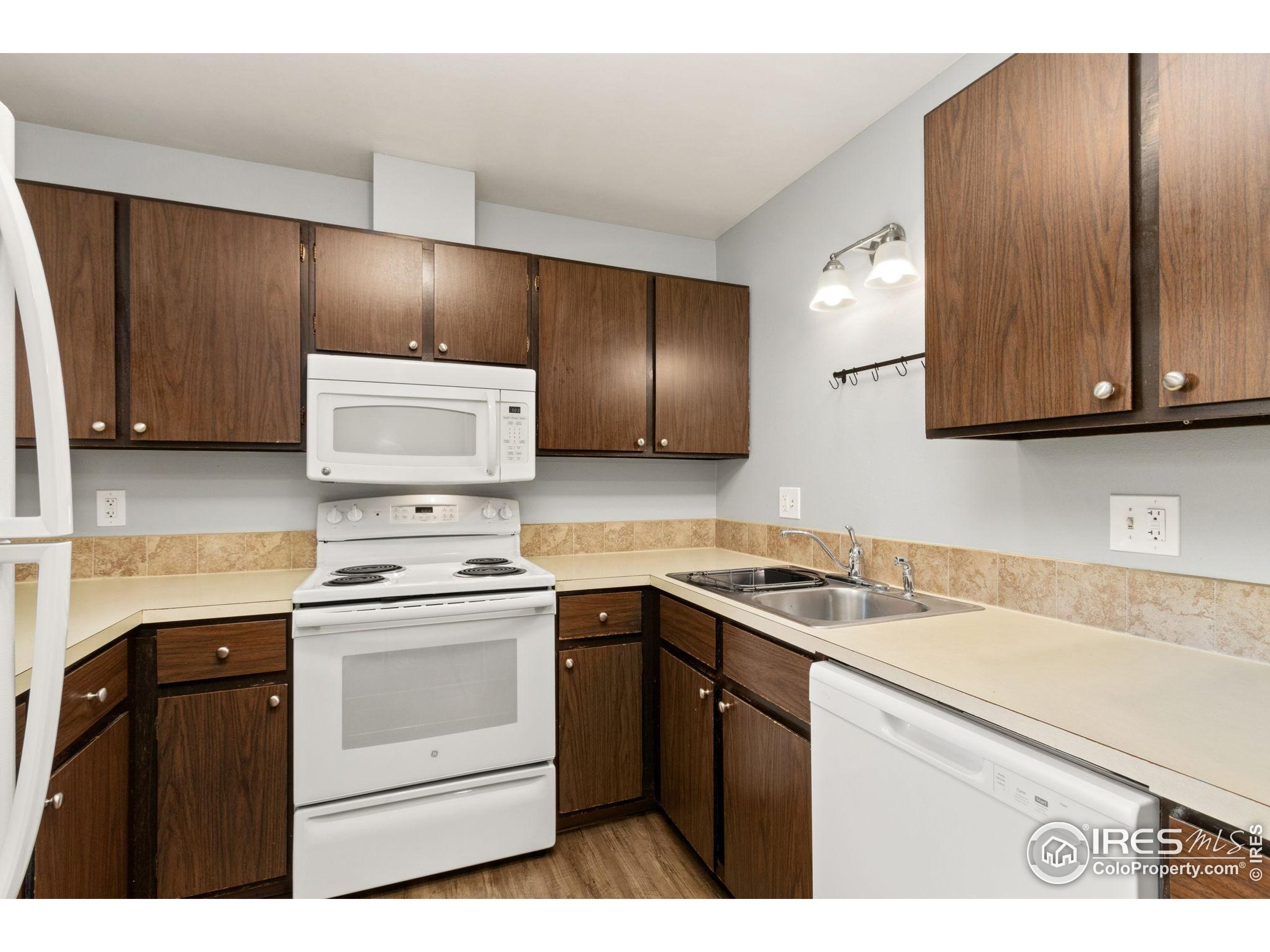 1625 West Elizabeth Street, Unit G2 Fort Collins, CO 80521 - Photo 10 of 45 a kitchen with stainless steel appliances granite countertop a sink stove and microwave