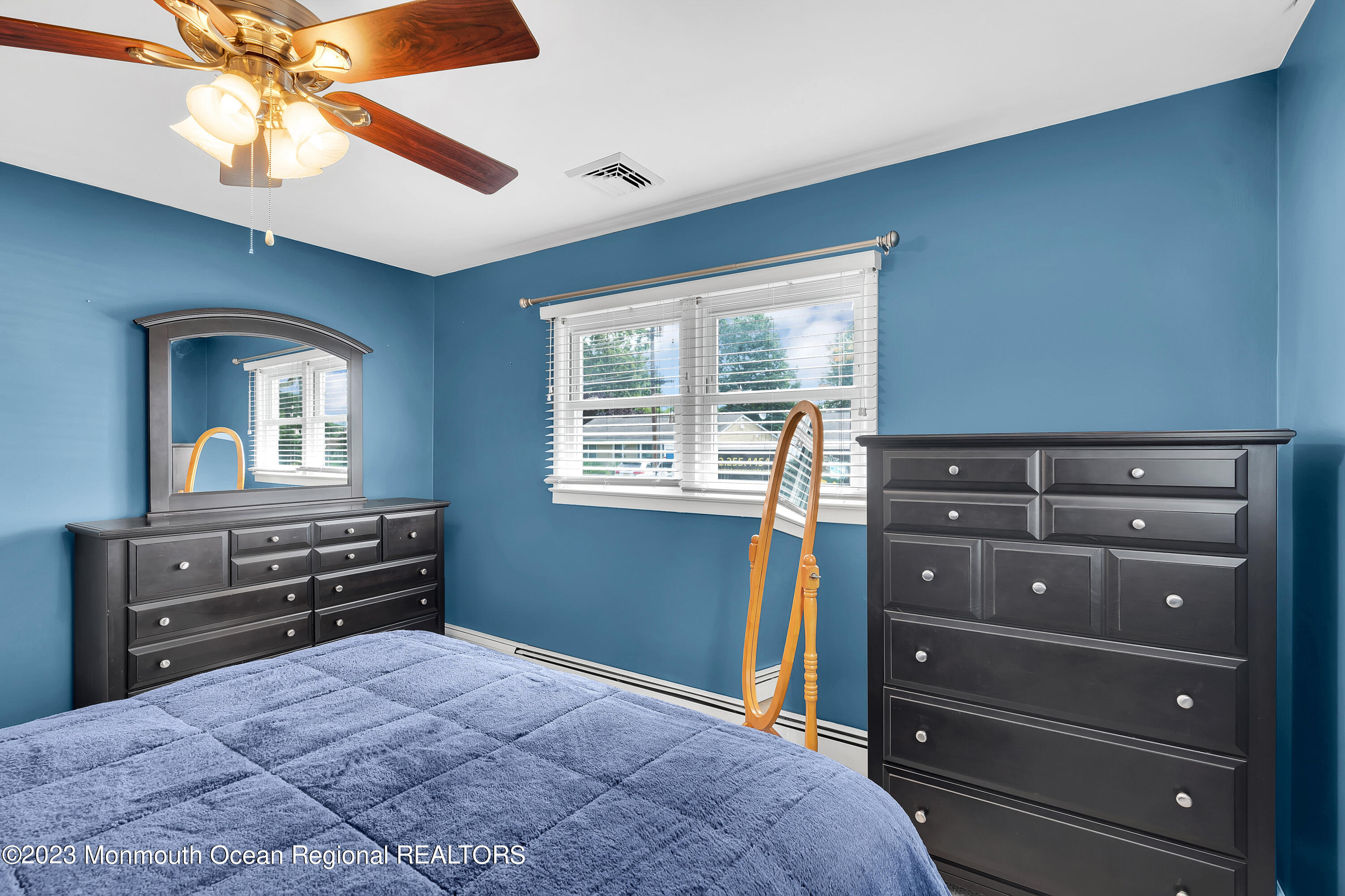 1313 Sleepy Hollow Road Point Pleasant, NJ 08742 - Photo 20 of 34 a bedroom with a bed and a mirror on the dresser