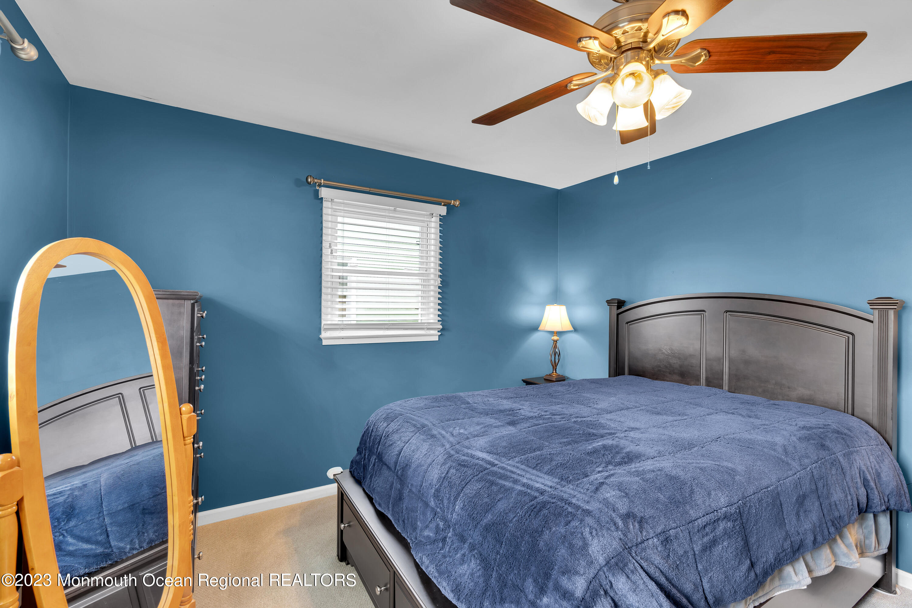 1313 Sleepy Hollow Road Point Pleasant, NJ 08742 - Photo 21 of 34 a bedroom with a bed and a chandelier