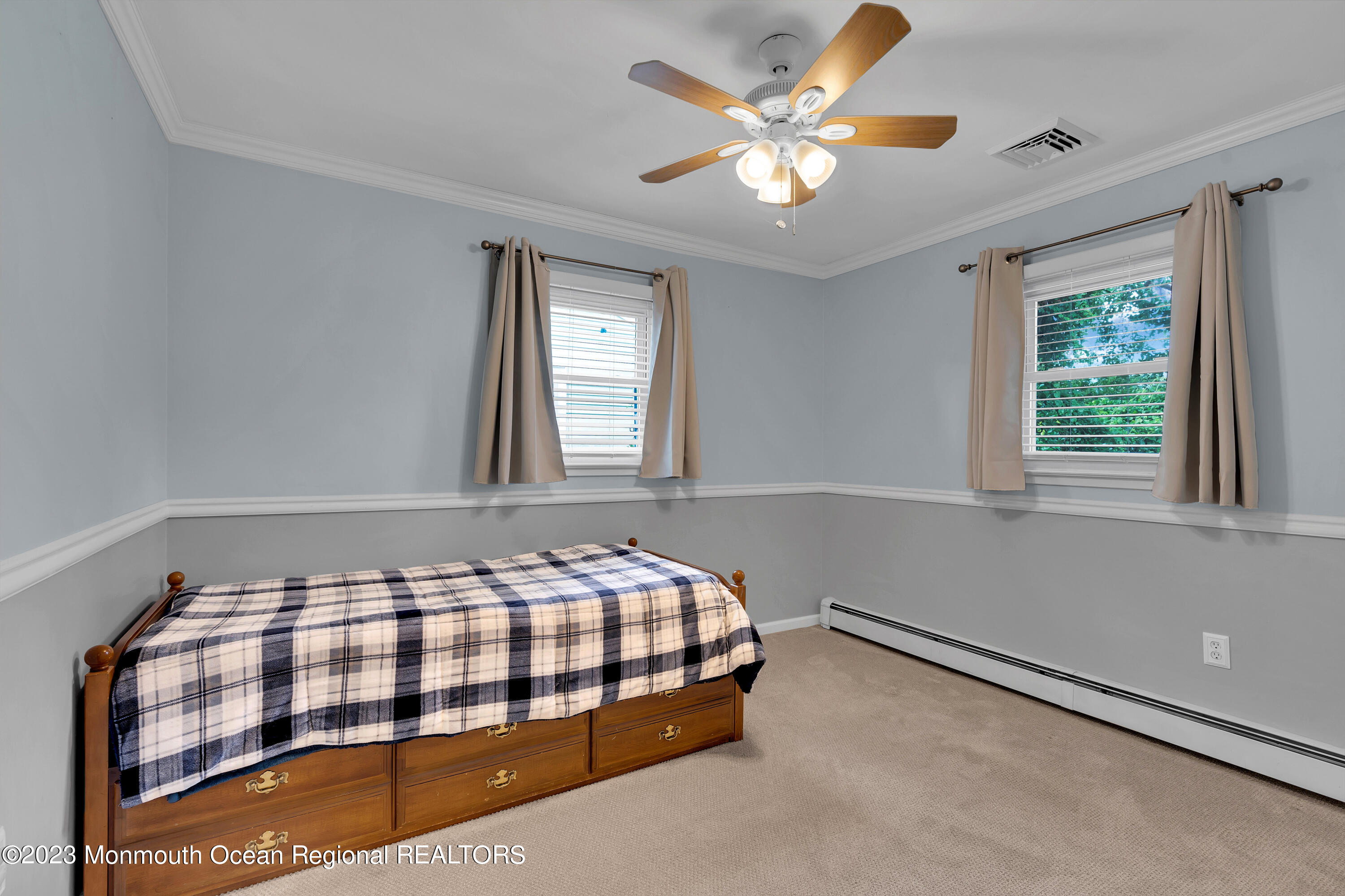1313 Sleepy Hollow Road Point Pleasant, NJ 08742 - Photo 24 of 34 a bedroom with a bed and a chandelier
