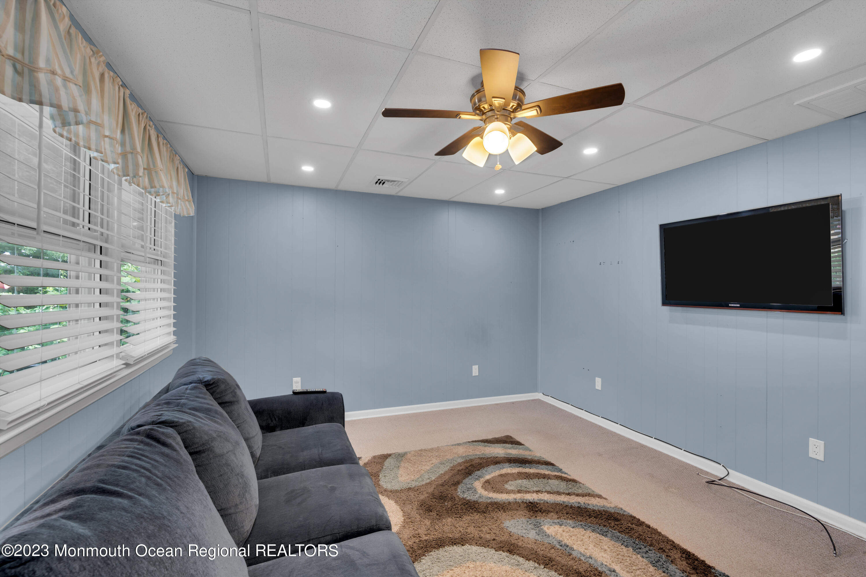 1313 Sleepy Hollow Road Point Pleasant, NJ 08742 - Photo 27 of 34 a living room with furniture and a flat screen tv
