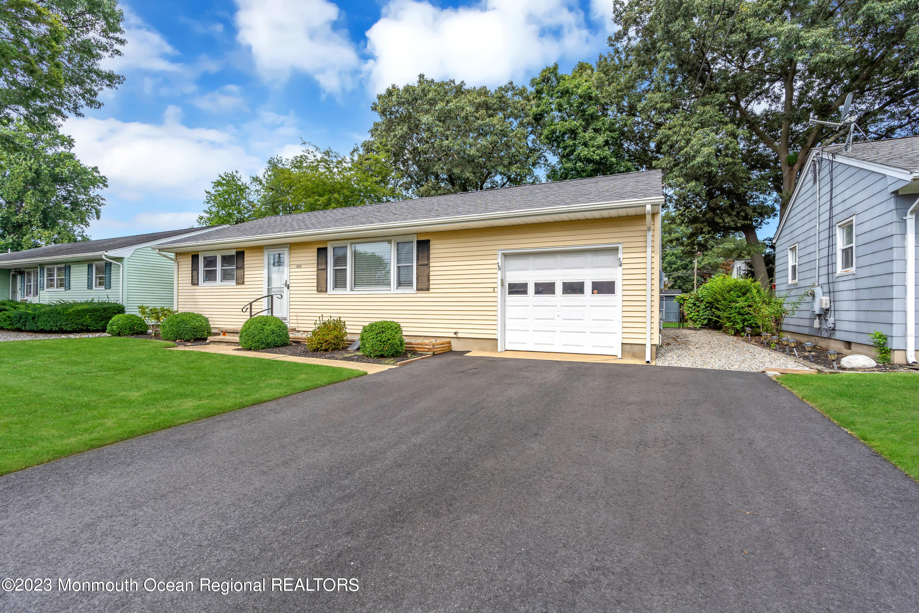 1313 Sleepy Hollow Road Point Pleasant, NJ 08742 - Photo 4 of 34 a view of a house with a yard and garage