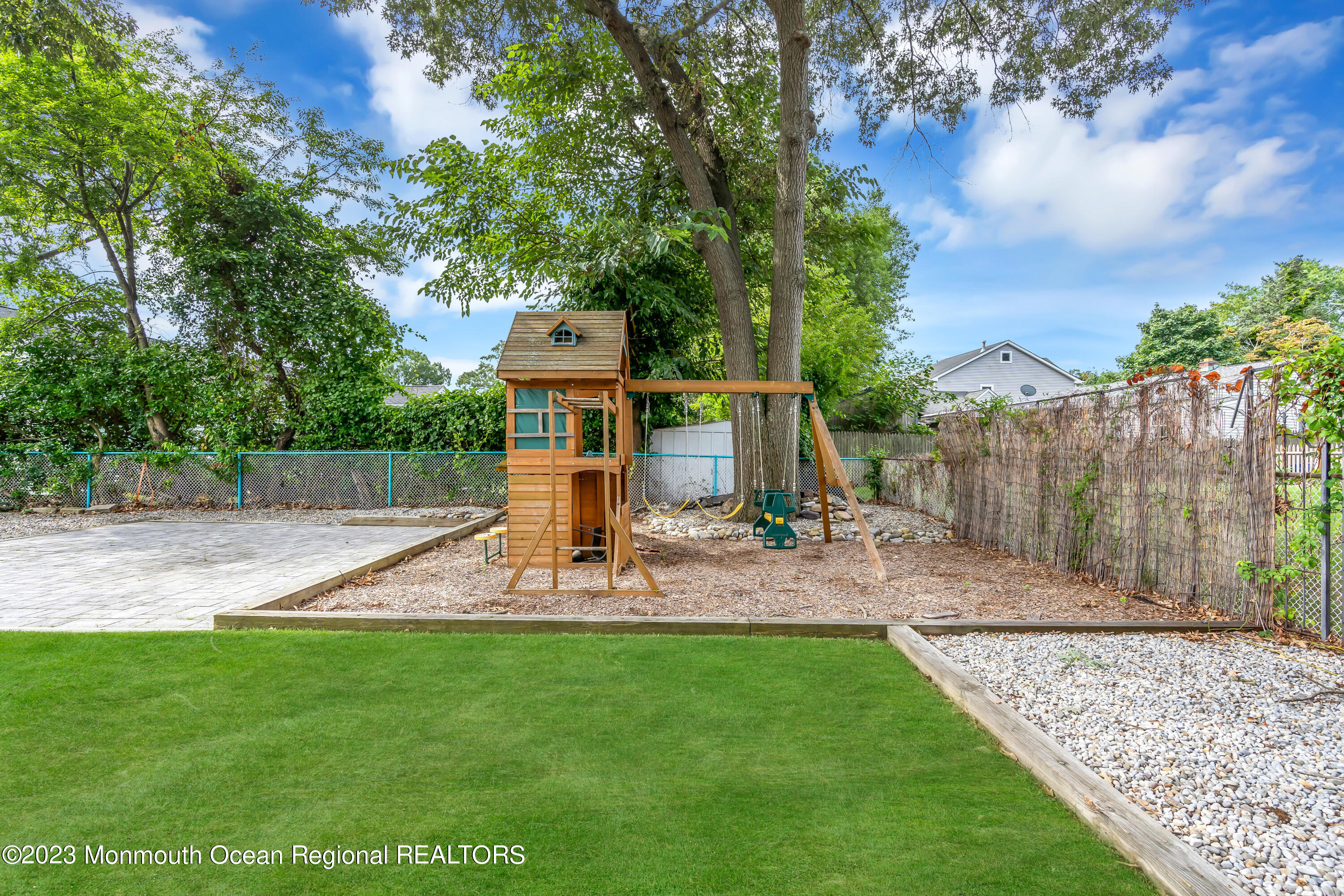 1313 Sleepy Hollow Road Point Pleasant, NJ 08742 - Photo 7 of 34 a view of a backyard with plants and large trees