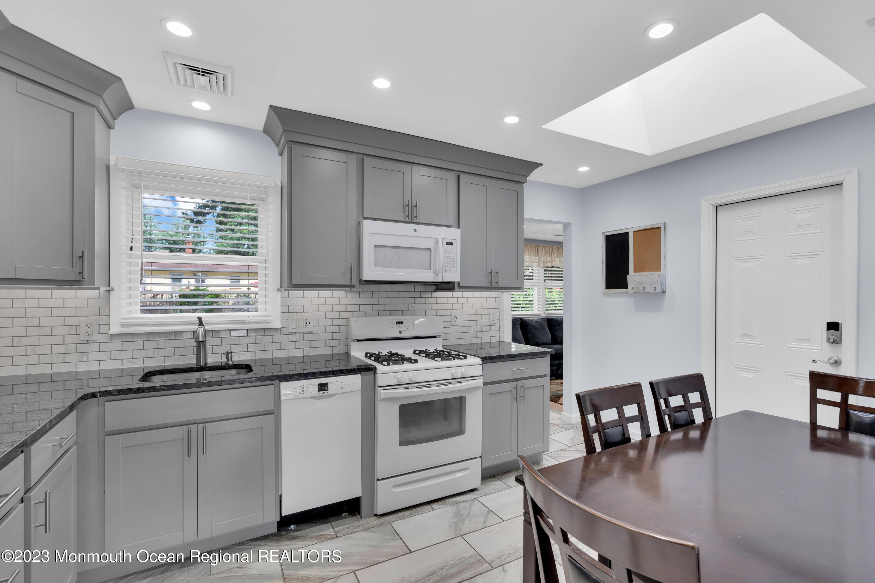 1313 Sleepy Hollow Road Point Pleasant, NJ 08742 - Photo 9 of 34 a kitchen with white cabinets and sink