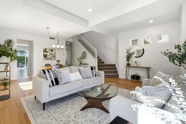 a bedroom with a bed and large windows