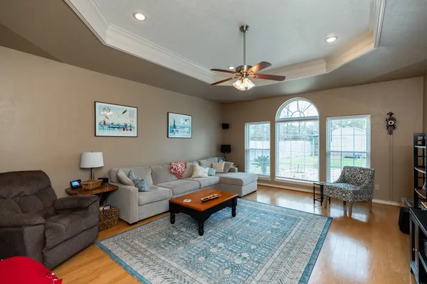 a living room with furniture a rug and a chandelier