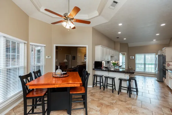 a view of a dining room with furniture and a chandelier