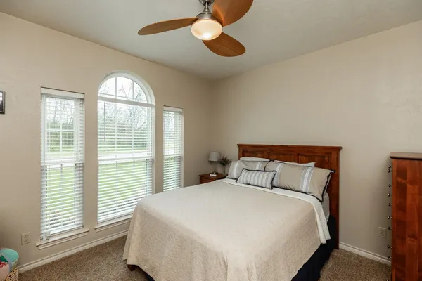 a bedroom with a large bed and a large window