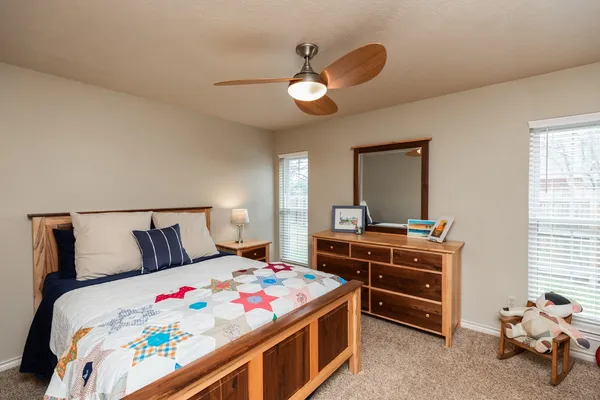 a bedroom with a bed and a chandelier