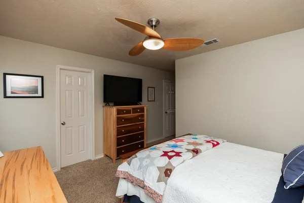 a bedroom with a bed and a flat screen tv