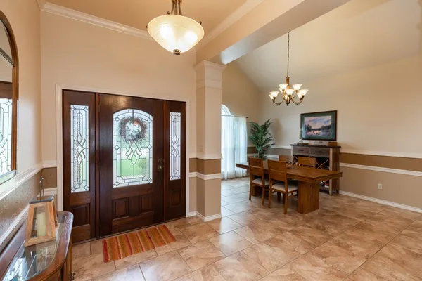 a view of a dining room with furniture and chandelier